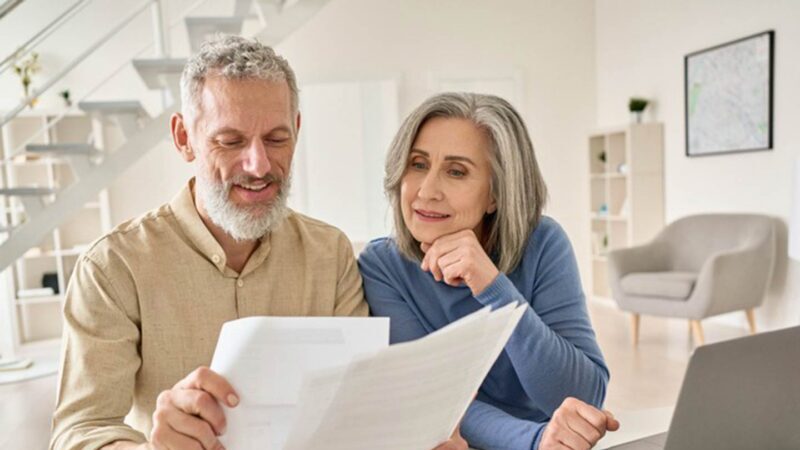 Retirement aged couple looking at documents