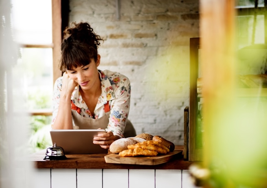 Stock image of small business owner looking at tablet.