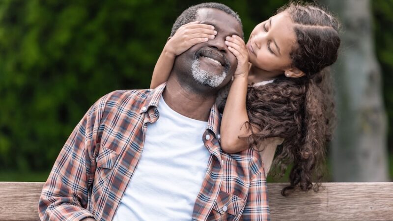Dad with daughter covering his eyes